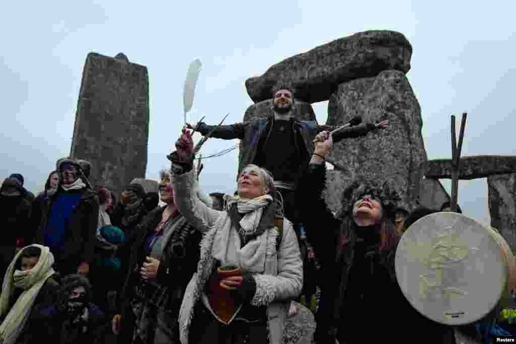 Revelers gather to celebrate the Summer Solstice at Stonehenge ancient stone circle, despite official events being cancelled amid the spread of the COVID-19, near Amesbury, Britain.