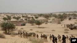 FILE - Chadian troops and Nigerian special forces participate in exercises in Mao, Chad, March 7, 2015. 
