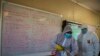 A disinfection team disinfects a classroom at Ivory Park Secondary School east of Johannesburg, South Africa, May 28, 2020, ahead of the June 1, 2020, reopening of Grade 7 and 12 learners to school.
