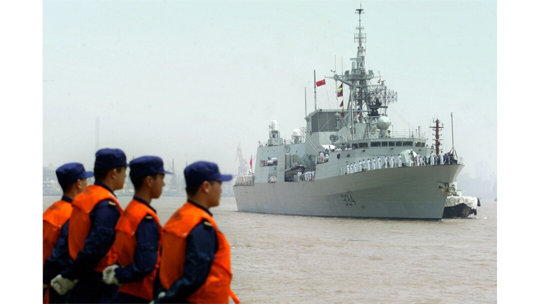 FILE - Chinese seamen stand as they welcome the arriving Canadian Navy Frigate, HMCS Regina in the port of Shanghai, Aug. 15, 2006.