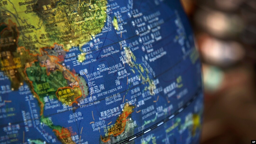 FILE - A globe shows the islands on the South China Sea with nine-dash line claims under Chinese territory on display at a bookstore in Beijing, July 13, 2018. 