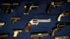 FILE - Guns seized by the police are displayed during a news conference in New York.