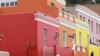 A man wearing a face mask to protect against coronavirus speaks to a woman in a building in Bo-Kaap Cape Town, South Africa, May 23, 2020.