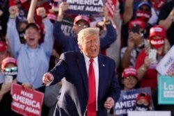 President Donald Trump works the crowd after speaking at a campaign rally Monday, Oct. 19, 2020, in Tucson, Ariz.