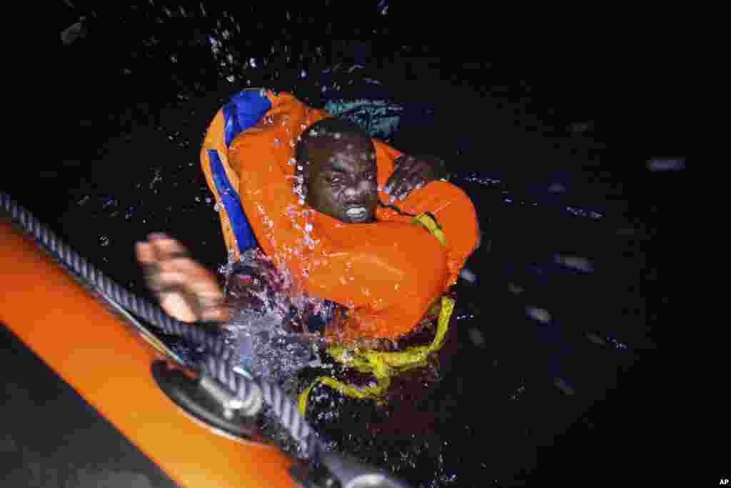 A migrant swims frantically towards a rescue ship off the coast of Libya.