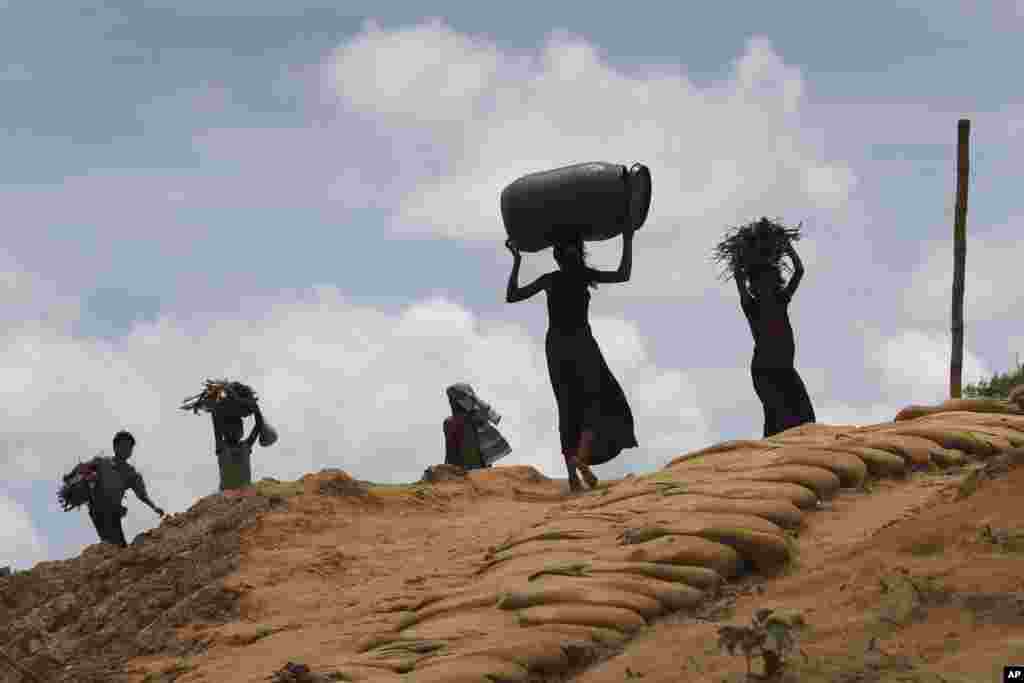 Rohingya girls make their way through Kutupalong refugee camp in Bangladesh.