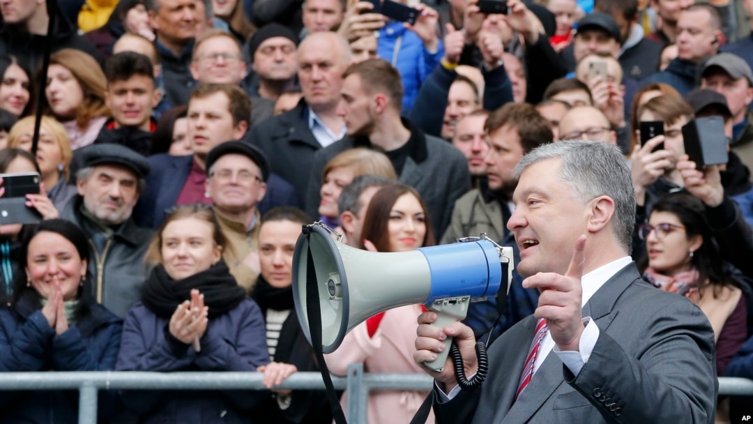Ukrainian President Petro Poroshenko speaks to a crowd ahead of the presidential elections on upcoming April 21, at the Olympic stadium in Kyiv, April 14, 2019.