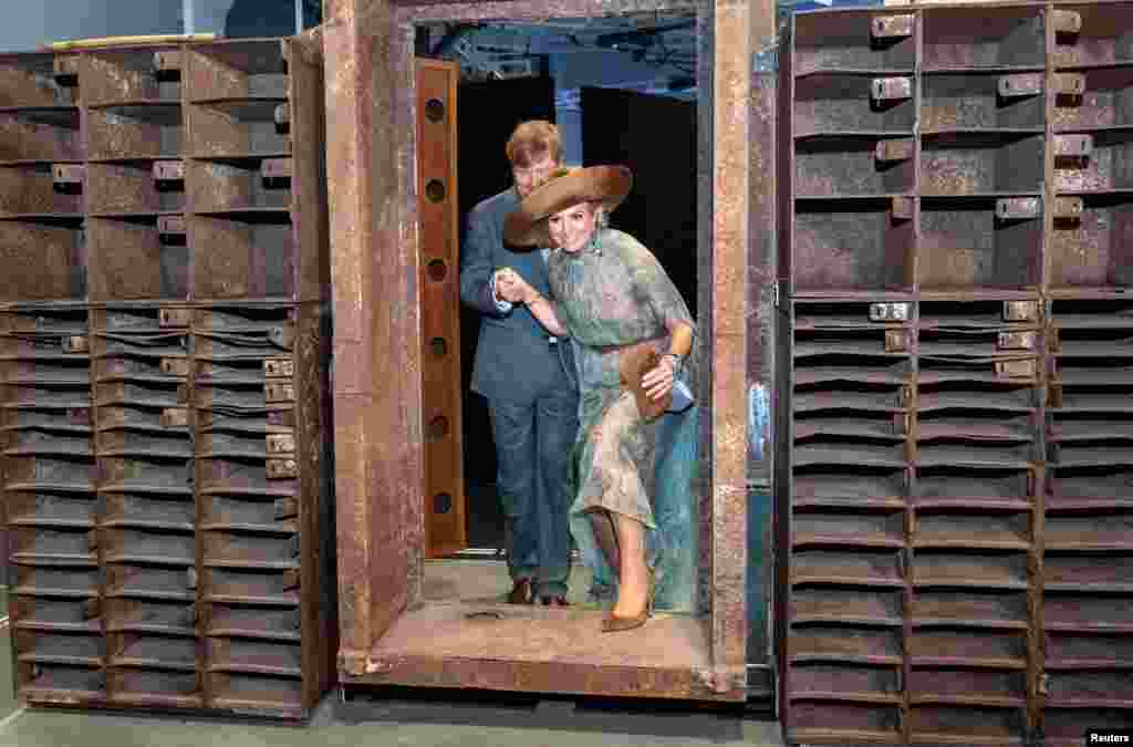 King Willem-Alexander and Queen Maxima of the Netherlands stand in the door of the former "Tresor" techno music club as they visit the "Berlin Global" exhibition at the Humboldt Forum museum and cultural centre in Berlin, Germany.
