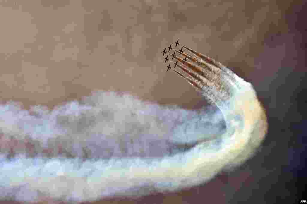 The Italian Air Force aerobatic unit Frecce Tricolori (Tricolor Arrows) prepares to spread smoke with the colors of the Italian flag prior the Moto GP Grand Prix at the Mugello race track.