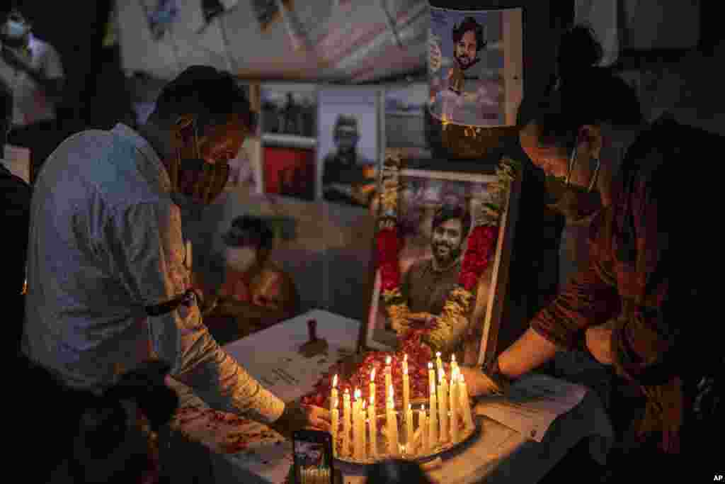 Journalists light candles and pay tribute to Reuters photographer Danish Siddiqui in New Delhi, India, July 17, 2021. The Pulitzer Prize-winning photographer was killed as he chronicled fighting between Afghan forces and the Taliban near a strategic border crossing.
