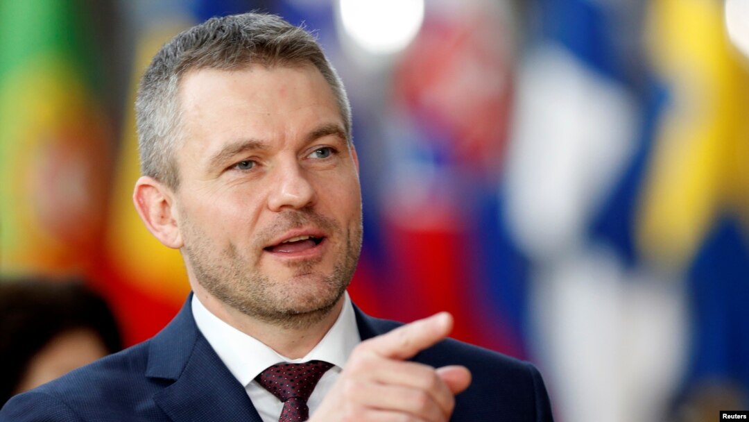 FILE - New Slovak Prime Minister Peter Pellegrini gestures as he arrives at a European Union summit in Brussels, Belgium, March 22, 2018. 