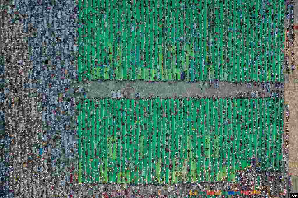 This aerial view shows Muslims attending the Eid Al-Adha prayer at Skenderbej Square in Tirana, Albania.
