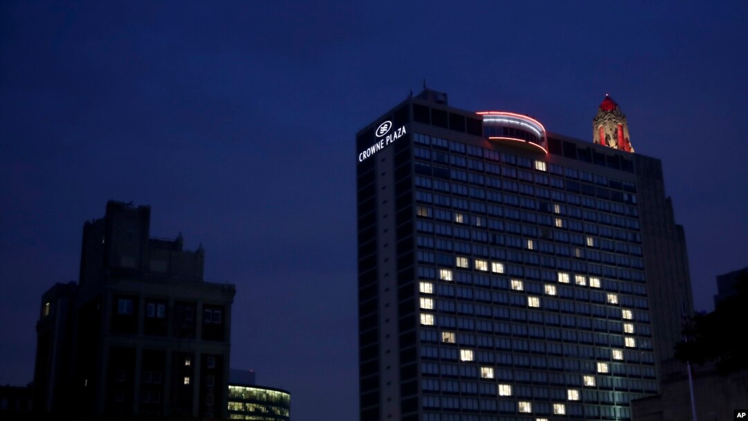 A downtown hotel leaves lights on in vacant room windows to form a heart Friday, March 27, 2020, in Kansas City, Mo.