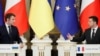 Ukrainian President Volodymyr Zelenskiy and French President Emmanuel Macron attend a news briefing following their talks in Kyiv, Feb. 8, 2022.