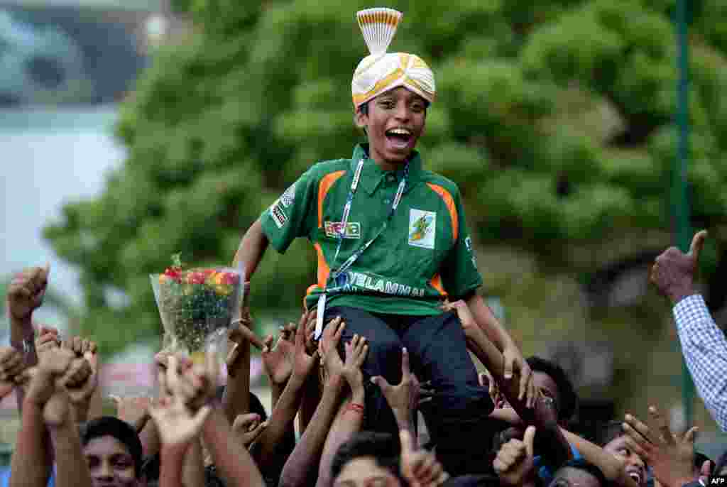 Indian chess prodigy Rameshbabu Praggnanandhaa, 12, celebrates upon arrival back to his school in Chennai after becoming the world's second youngest chess grandmaster ever.