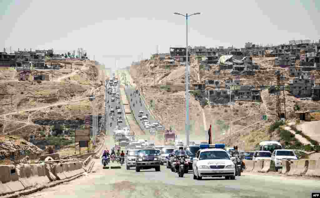 Government cars and military vehicles driving along the main highway between Homs and Hama. The Homs-Hama highway was restored and re-opened after reportedly being closed for around seven years, according to the official Syrian Arab News Agency (SANA).