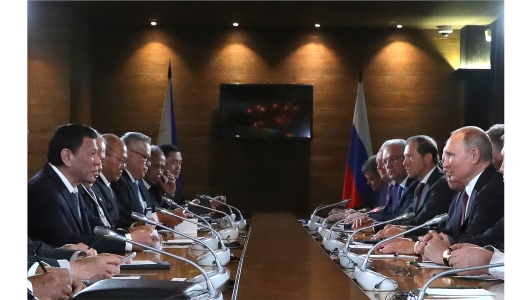 Russian President Vladimir Putin (R) and Philippine's President Rodrigo Duterte, both flanked by officials, are seen meeting in Sochi, Russia, Oct. 3, 2019.