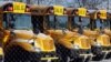 FILE - School buses are parked at the Skokie School District 68 parking lot in Skokie, Ill.