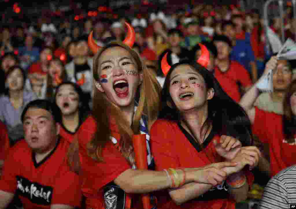 South Korean soccer fans celebrate as they watch the Group F World Cup soccer match between South Korea and Germany, at a public viewing venue in Seoul, South Korea.