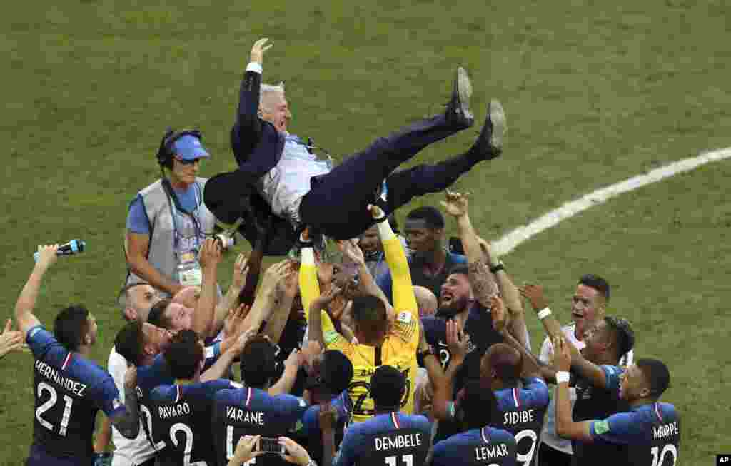 French players throw their head coach Didier Deschamps into the air to celebrate at the end of the final match between France and Croatia at the 2018 soccer World Cup in the Luzhniki Stadium in Moscow, Russia. France won its second World Cup title by beating Croatia 4-2.