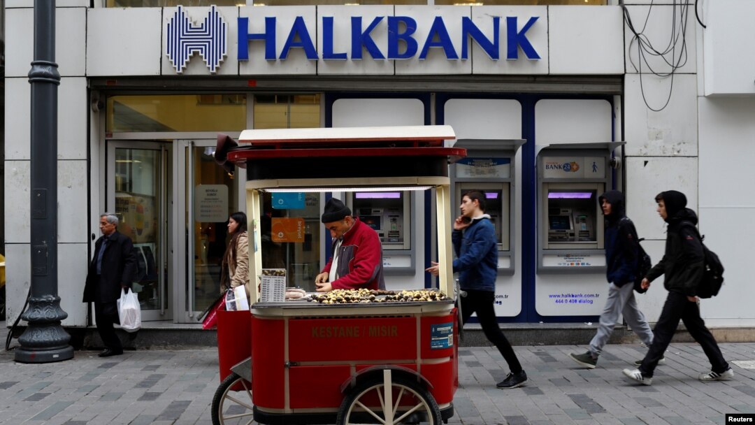 A street vendor sells roasted chestnuts in front of a branch of Halkbank in central Istanbul, Turkey, Jan. 10, 2018. 