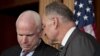 Sen. John McCain, R-Ariz., left, and Sen. Charles Schumer, D-N.Y., right, confer as they and other leading senators announce that they have reached agreement on the principles of sweeping legislation to rewrite the nation's immigration laws, during a news