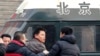 Zhang Xuezhong (C), a lawyer for Chinese dissident Zhao Changqing, argues with plain-clothed policemen as he refuses to show them his identification card when he was stopped and questioned by them on his way to court to attend Zhao's trial in Beijing, Jan. 23, 2014.