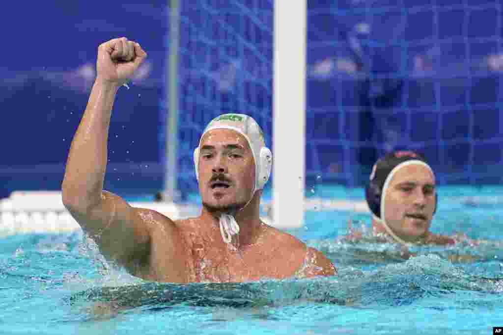 South Africa's Nardus Badenhorst, left, celebrates after scoring against the United States during a preliminary round men's water polo match at the 2020 Summer Olympics, Tuesday, July 27, 2021, in Tokyo, Japan. (AP Photo/Mark Humphrey)