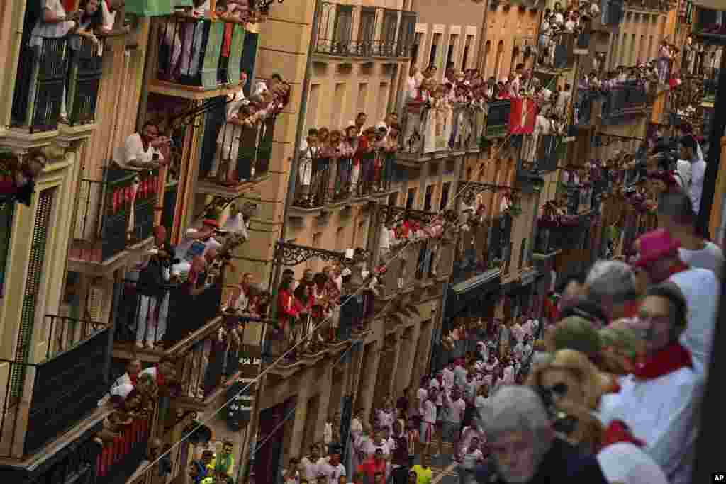 People on balconies wait for the start on the third day of the running of the bulls at the San Fermin Festival in Pamplona, northern Spain.