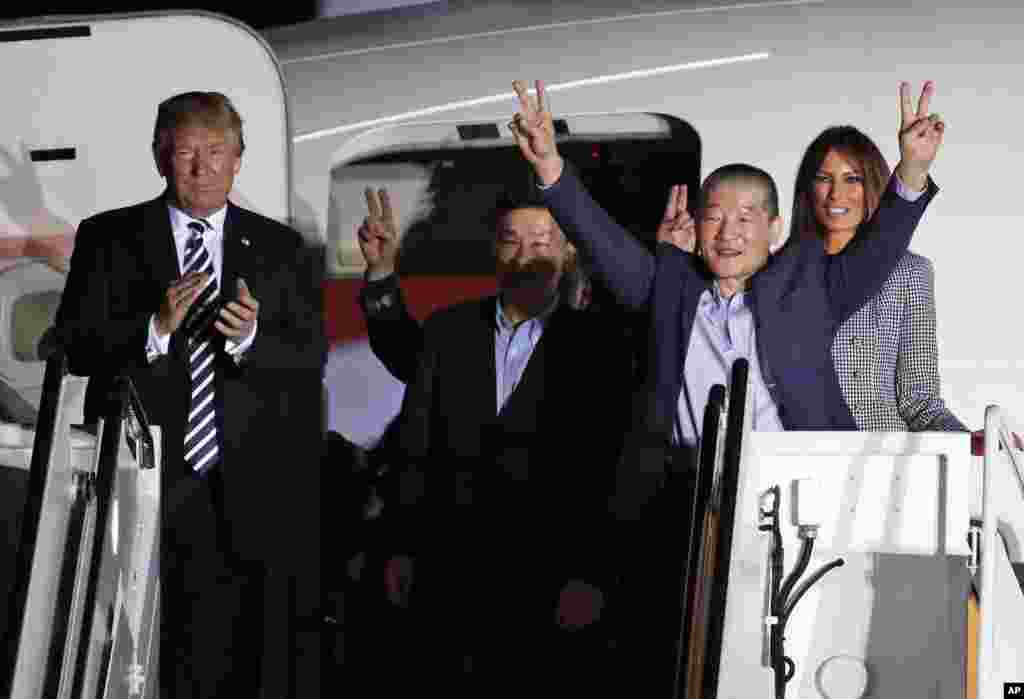 President Donald Trump and first lady Melania Trump greet former North Korean detainees Kim Dong Chul, second right, Tony Kim, center, and Kim Hak Song, behind Tony Kim, upon their arrival at Andrews Air Force Base, Maryland.