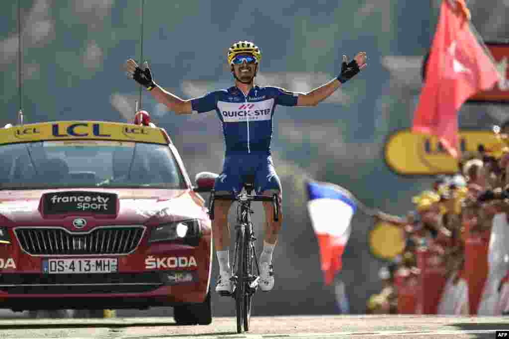France's Julian Alaphilippe celebrates as he crosses the finish line to win the 10th stage between Annecy and Le Grand-Bornand, French Alps, of the 105th edition of the Tour de France cycling race.
