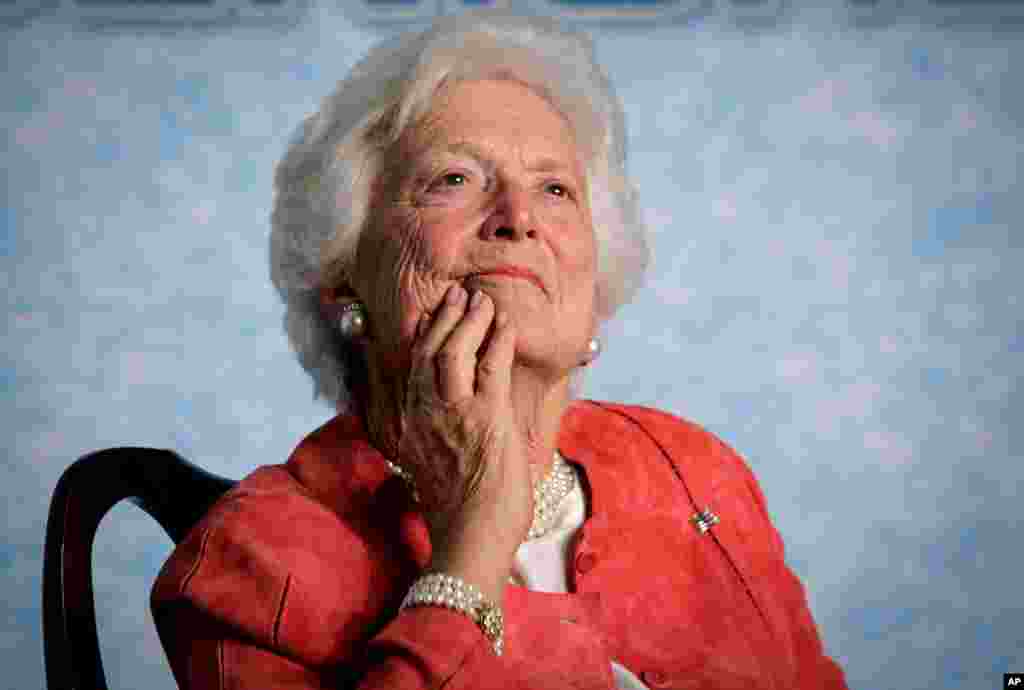 FILE - Former first lady Barbara Bush listens to her son, President George W. Bush, as he speaks on Social Security reform in Orlando, Florida, March 18, 2005.
