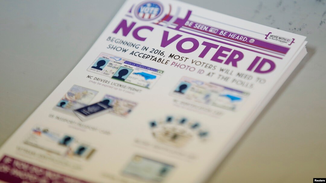 A pile of government pamphlets explaining North Carolina's controversial voter ID law sits on table at a polling station.