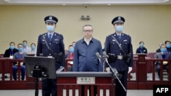 File - Photo of August 11, 2020, released by the Second Intermediate People’s Court of Tianjin, shows Lai Xiaomin (C), former chairman of China Huarong Asset Management Co., standing during his trial at the Second Intermediate People’s Court in Tianjin.