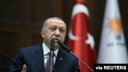 FILE - Turkish President Tayyip Erdogan addresses lawmakers from his ruling AK Party during a meeting at the parliament in Ankara, Turkey.