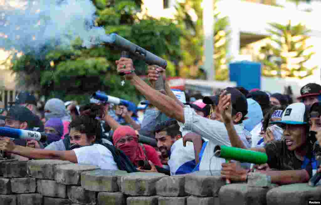 Demonstrators fire a homemade mortar during a protest against Nicaragua's President Daniel Ortega's government in Managua, May 30, 2018.