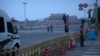 China Tiananmen Anniversary: A pair of late-arriving visitors run to watch the daily flag-raising ceremony at dawn at Tiananmen Square in Beijing, Saturday, June 4, 2016.
