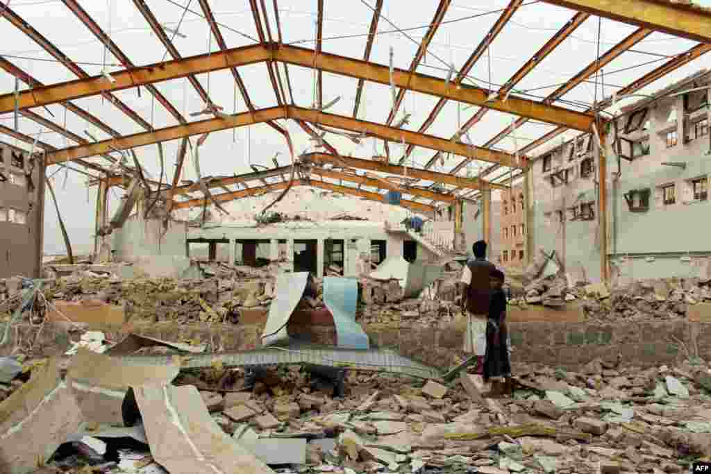 Yemenis inspect the damage caused by a Saudi-led airstrike on a cholera treatment center supported by Doctors Without Borders (MSF) in the Abs region of Yemen. MSF said it has temporarily frozen operations in the rebel-held area of northwestern Yemen following the airstrike which caused no casualties.