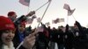 Spectators wave American flags on the National Mall in Washington, Jan. 21, 2013, before the start of President Barack Obama's ceremonial swearing-in ceremony during the 57th Presidential Inauguration.
