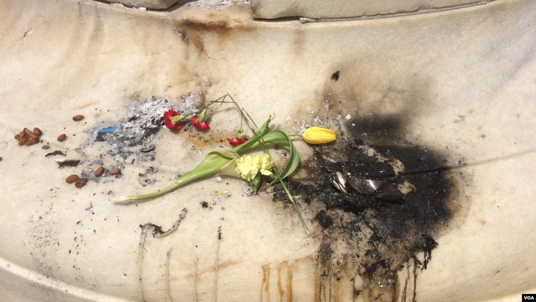 Items left at an impromptu memorial in Washington for slain Muslim teen Nabra Hassanen were set on fire, June 21, 2017. (E. Sarai/VOA)