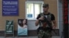 An armed serviceman stands guard at a cordon near a cafe, where leader of the separatist self-proclaimed Donetsk People's Republic Alexander Zakharchenko was killed, in Donetsk, Ukraine, Aug. 31, 2018.