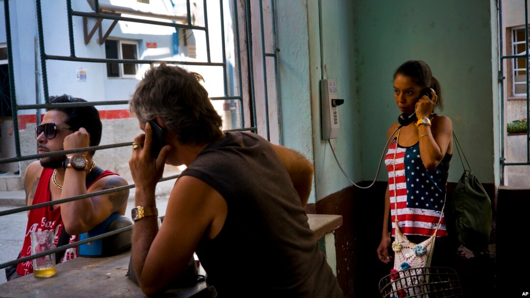 A woman talks on the phone at a coffee shop, in Havana, Cuba, March 15, 2016. Five days ahead of the first presidential trip to Havana in nearly 90 years, the U.S. eliminated a ban on Cuban access to the international banking system. 