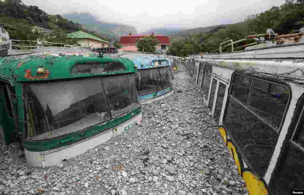 Trolleybuses are seen damaged after heavy rainfall and floods in Yalta, Crimea.