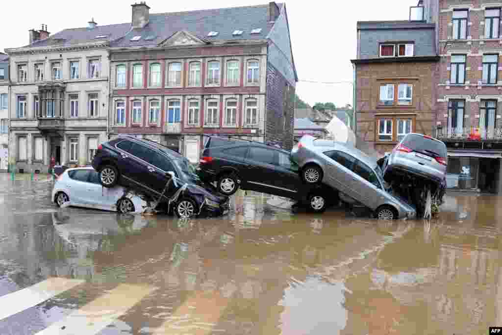 Cars are piled up by the water at a roundabout in the Belgian city of Verviers, after heavy rains and floods lashed western Europe, killing at least two people in Belgium.