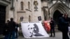 A banner in support of WikiLeaks founder Julian Assange is attached outside the Royal Courts of Justice, in London, Oct. 23, 2021, ahead of an upcoming extradition case appeal. 