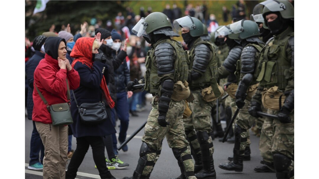 Belarusian law enforcement officers block opposition supporters during their rally to reject the presidential election results in Minsk, Belarus, Nov. 1, 2020.