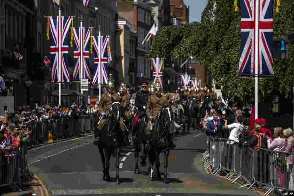 Members of the Armed Forces ride horses during a parade rehearsal, ahead of Prince Harry and Meghan Markle&#39;s wedding in Windsor, England.