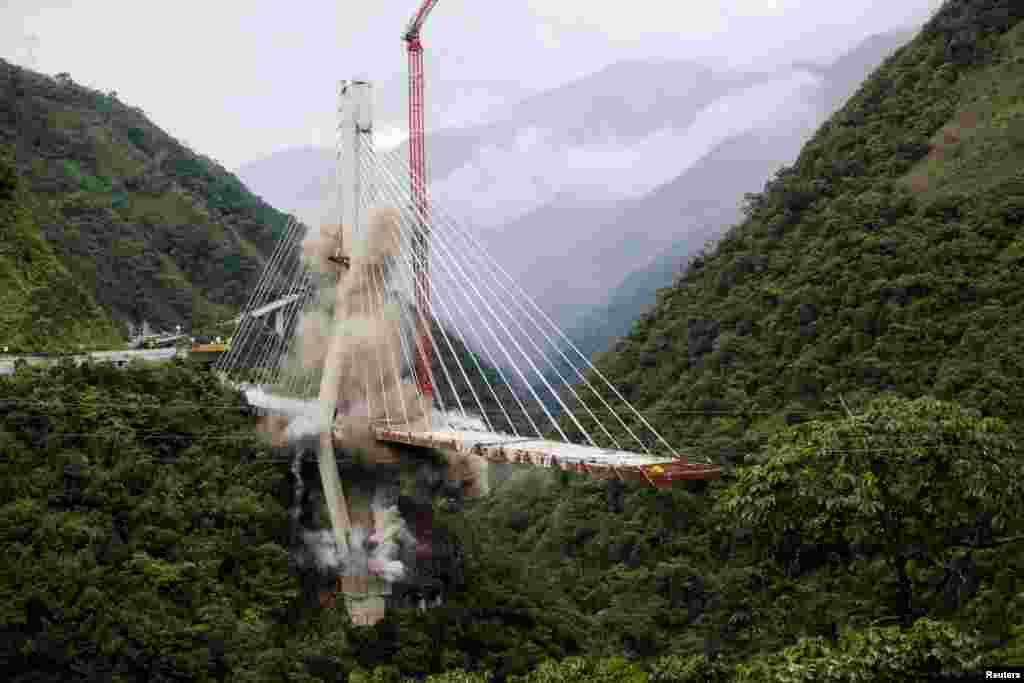 The Chirajara bridge is demolished in a controlled implosion, after it partially collapsed, killing several people earlier this year, in Guayabetal, Colombia, July 11, 2018.