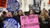 FILE - Pro-choice supporters demonstrate in front of the U.S. Supreme Court during the National March for Life rally in Washington, Jan. 22, 2016. The rally marks the 43rd anniversary of the U.S. Supreme Court's 1973 abortion ruling in Roe v. Wade.