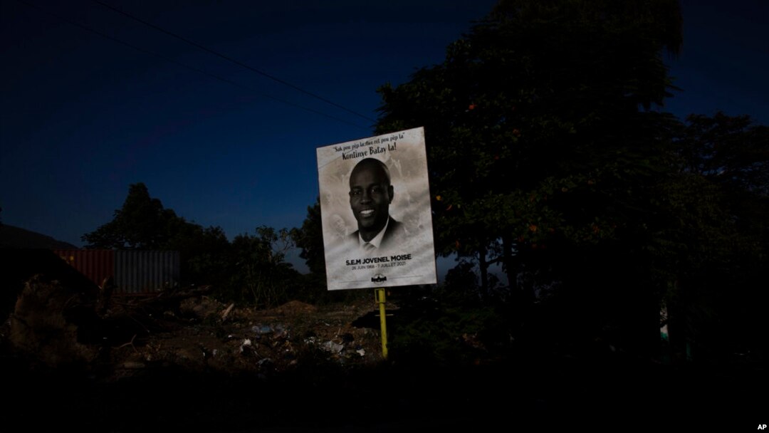 FILE - A poster depicting Haiti's President Jovenel Moise, who was assassinated in July, towers over a road in Port-au-Prince, Haiti, Sept. 28, 2021.